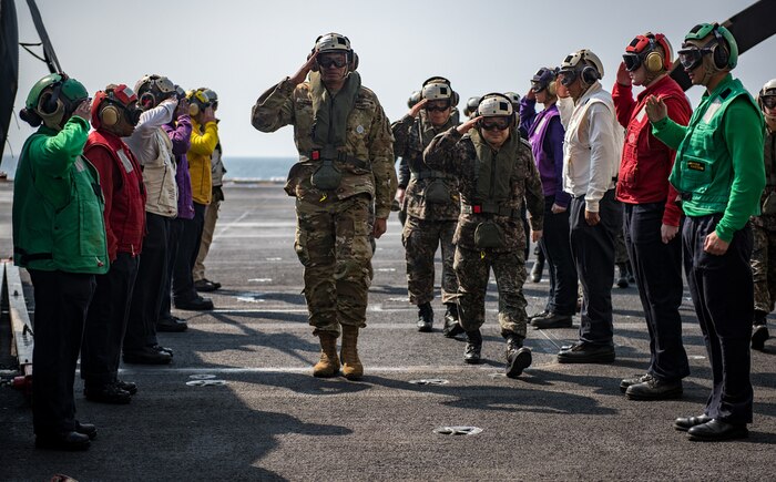 Sideboys from the aircraft carrier USS Carl Vinson (CVN 70) render honors to Gen. Vincent K. Brooks, commander, United Nations Command/Combined Forces Command/U.S. Forces Korea, center left, Gen. Lee, Sun Jin, chairman of the Republic of Korea Joint Chiefs of Staff, center right, and Gen. Leem, Ho-young, deputy commander, Combined Force, Republic of Korea, center, on the flight deck, Mar. 12, 2017. The Carl Vinson Carrier Strike Group is on a regularly scheduled Western Pacific deployment as part of the U.S. Pacific Fleet-led initiative to extend the command and control functions of U.S. 3rd Fleet. U.S Navy aircraft carrier strike groups have patrolled the Indo-Asia-Pacific regularly and routinely for more than 70 years. 