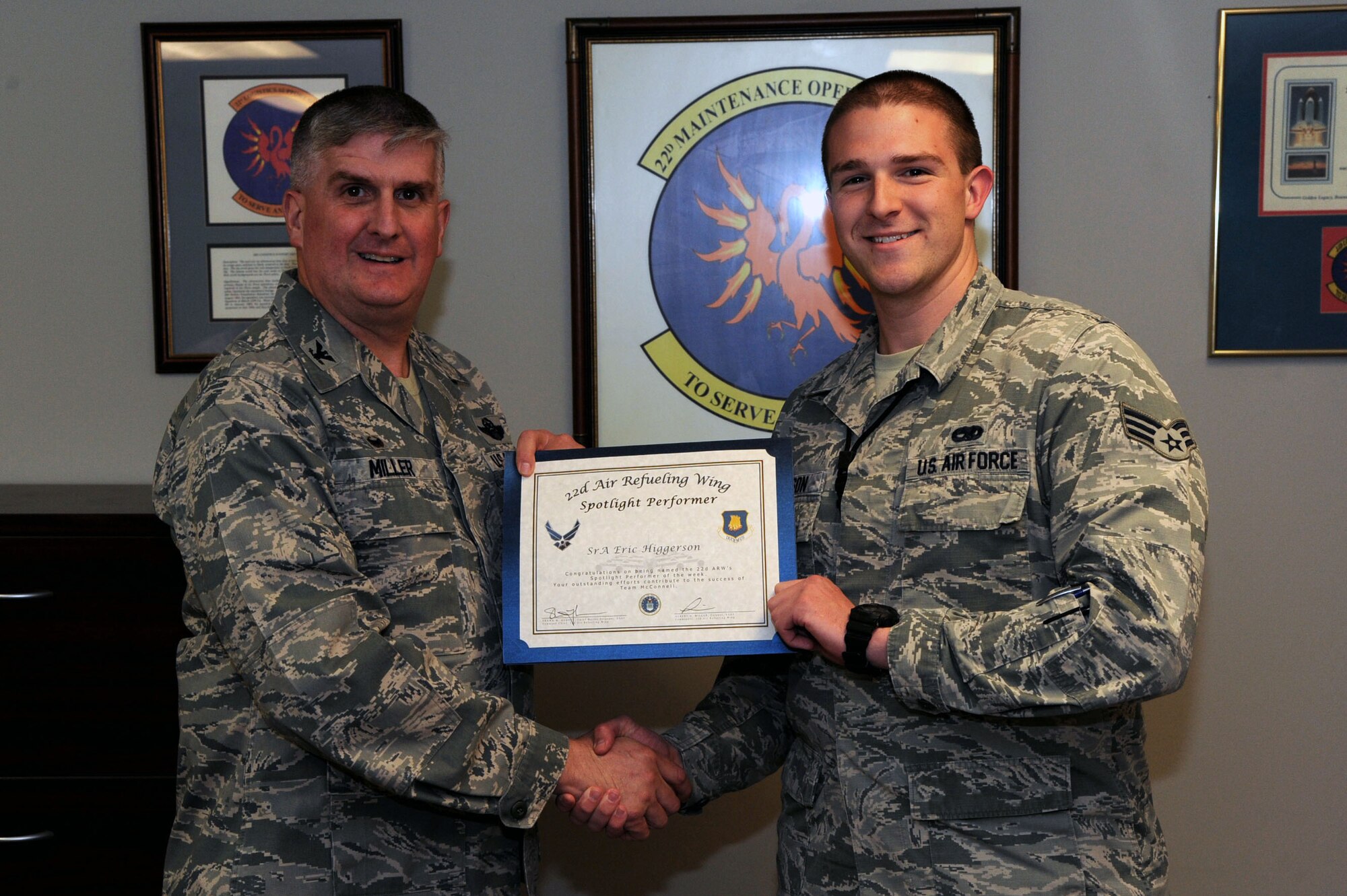 Senior Airman Eric Higgerson, 22nd Maintenance Group maintenance scheduler, poses with Col. Albert Miller, 22nd Air Refueling Wing commander, March 13, 2017, at McConnell Air Force Base, Kan. Higgerson received the spotlight performer for the week of Feb. 13–17. (U.S. Air Force photo/Airman 1st Class Jenna K. Caldwell) 