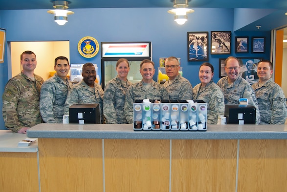 The Minot chapel staff poses in their juice and coffee bar where they serve Airmen free refreshments at Minot Air Force Base, N.D., March 13, 2017. The staff was awarded with the Charles I. Carpenter Award for being the Air Force’s Outstanding Large Chapel Team. (U.S. Air Force photo/Senior Airman Christian Sullivan)