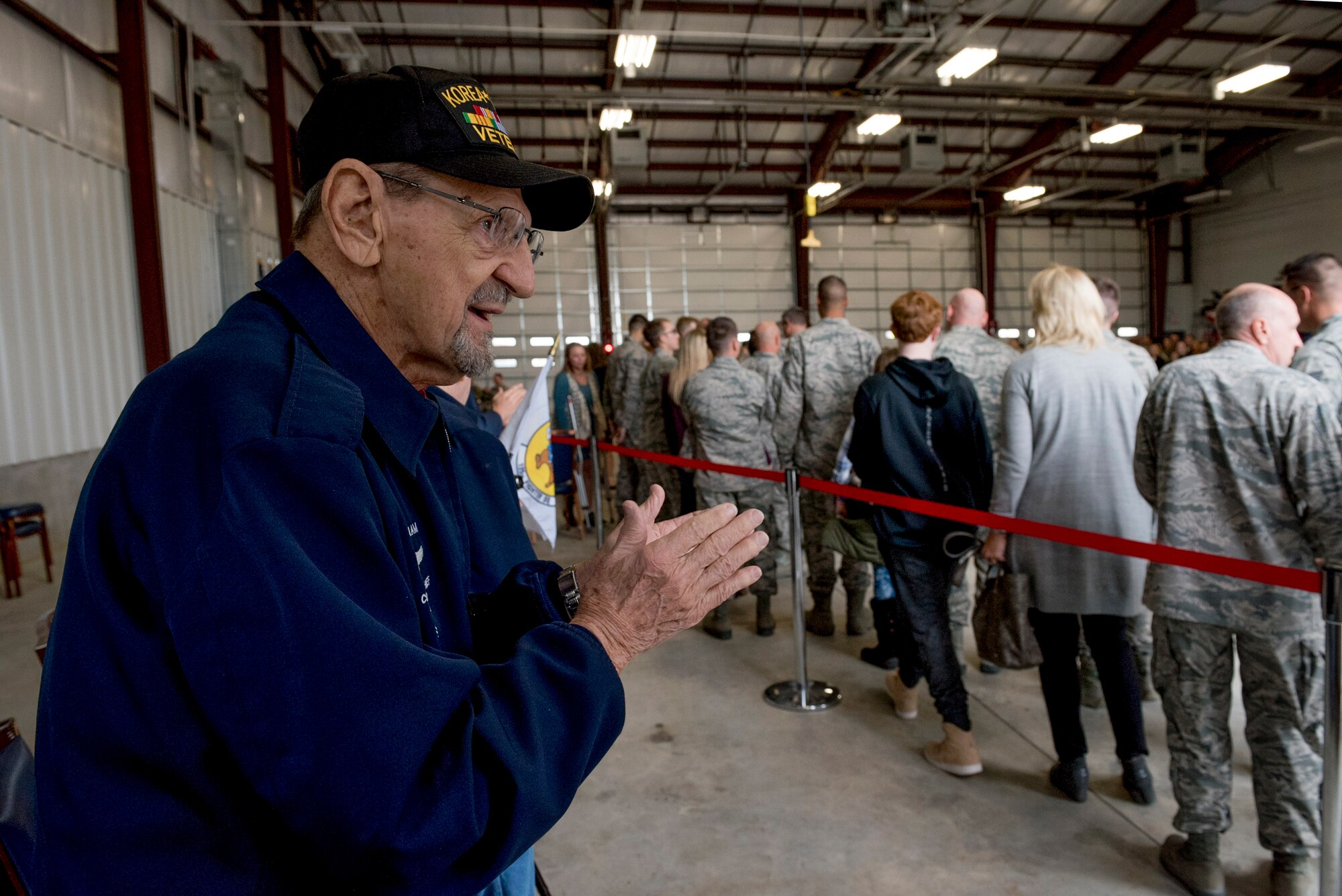 Retired Command Chief Master Sergeant George Banasky welcomes home Airmen from deployment during a ceremony at the 138th Fighter Wing in Tulsa, Okla., March 5, 2017. Banasky is a member of the Silver Beavers, a Heritage Committee made up of retired members of the 138th FW. (U.S. Air National Guard photo by Senior Airman Rebecca Imwalle)