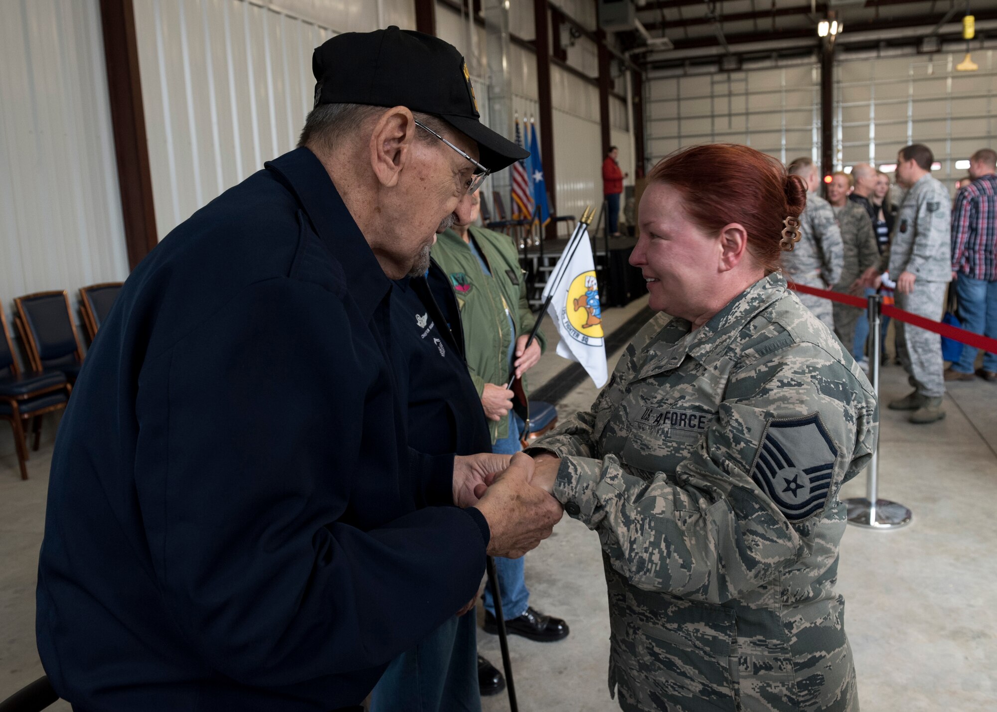 Retired Command Chief Master Sergeant George Banasky, (left) speaks with Master Sgt. Darlene Kirk during a homecoming ceremony at the 138th Fighter Wing in Tulsa, Okla., March 5, 2017. Members of the Silver Beavers and Blue Star Mothers attended this event to show their support of the Airmen who deployed and to welcome them home. (U.S. Air National Guard photo by Senior Airman Rebecca Imwalle)