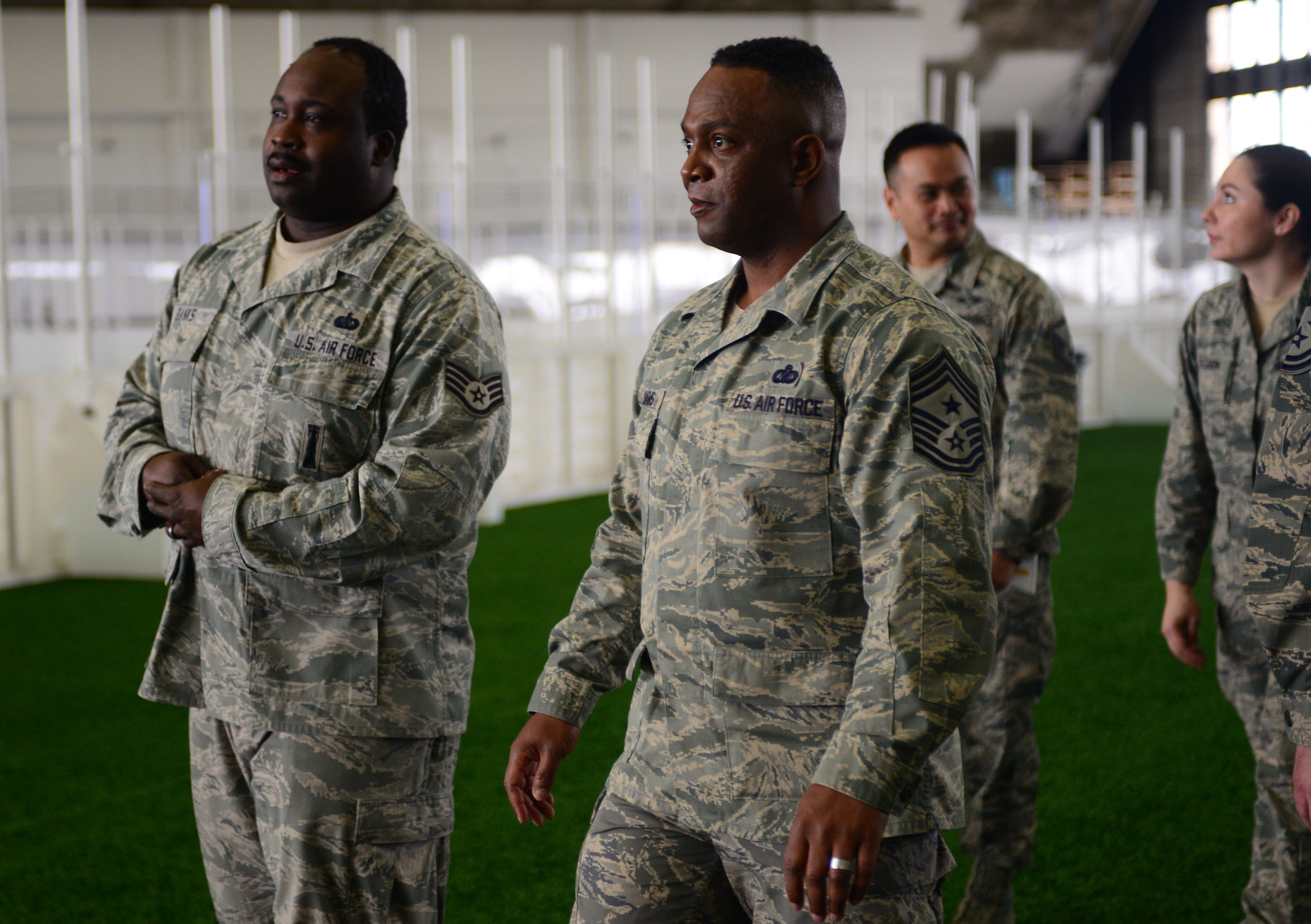 Staff Sgt. Adrian Banks, the Bellamy Fitness Center facility supervisor assigned to the 28th Force Support Squadron, escorts Chief Master Sgt. Calvin Williams, Air Force Global Strike Command command chief, through the Pride Hangar during a visit to Ellsworth Air Force Base, S.D., March 2, 2017. Banks explained the recent updates to the Pride Hangar, including a new indoor soccer field, batting areas and improved lighting. (U.S. Air Force photo by Airman 1st Class Denise M. Jenson)