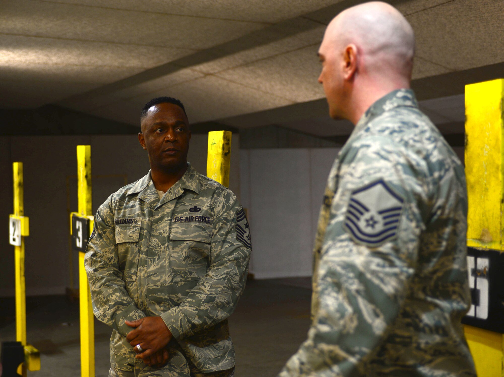 Master Sgt. Tyler Conner, a combat arms instructor assigned to the 28th Security Forces, right, shows Chief Master Sgt. Calvin Williams, Air Force Global Strike Command command chief, around the combat arms training facility during a visit to Ellsworth Air Force Base, S.D., March 2, 2017. The rifle course includes real-world scenarios to make Airmen more proficient in close-quarters combat situations such as rounding corners and shooting while moving. (U.S. Air Force photo by Airman 1st Class Denise M. Jenson)