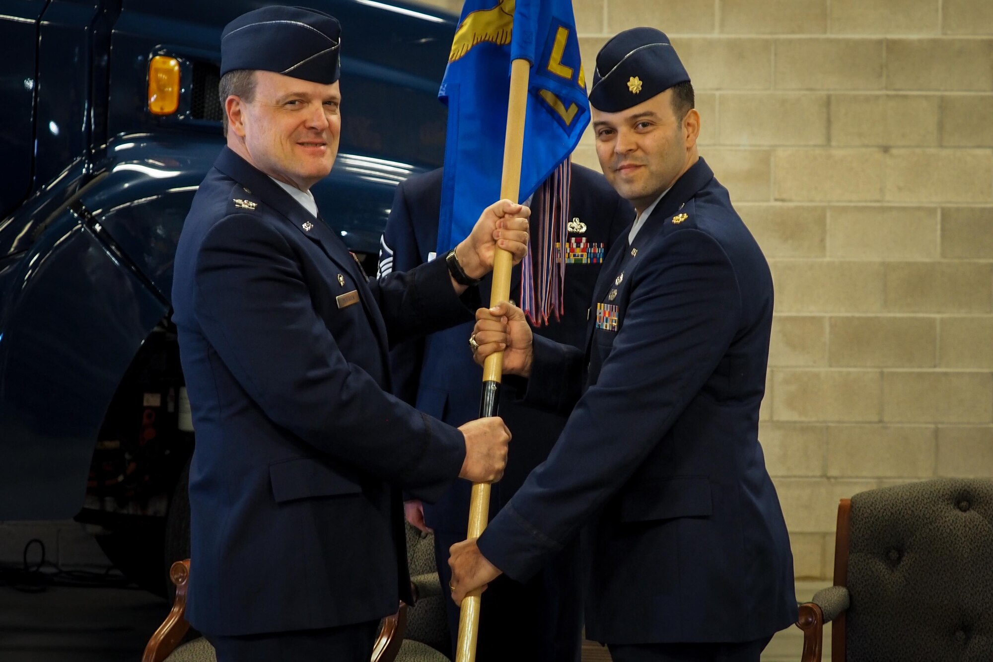 Maj. Lajara Sanchez accepts the guidon for the 934th Logistics Readiness Squadron from Col. Craig Petersen, 934th Mission support Group commander, as he assumes command of the LRS March 4.