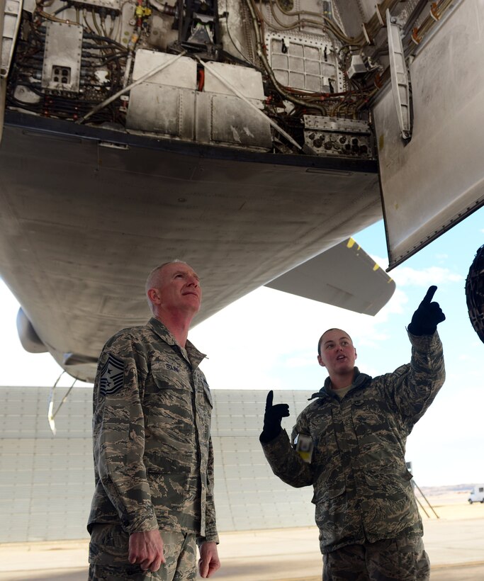 Airman 1st Class Sharon Snow, an aircraft armament systems journeyman assigned to the 28th Aircraft Maintenance Squadron, gives Chief Master Sgt. Alan Boling, command chief for the 8th Air Force, a tour of the B-1 bomber during a visit to Ellsworth Air Force Base, S.D., March 8, 2017. The B-1 bomber is one of the three bombers under the 8th Air Force, the others being the B-2 and B-52. (U.S. Air Force photo by Airman 1st Class Donald C. Knechtel)