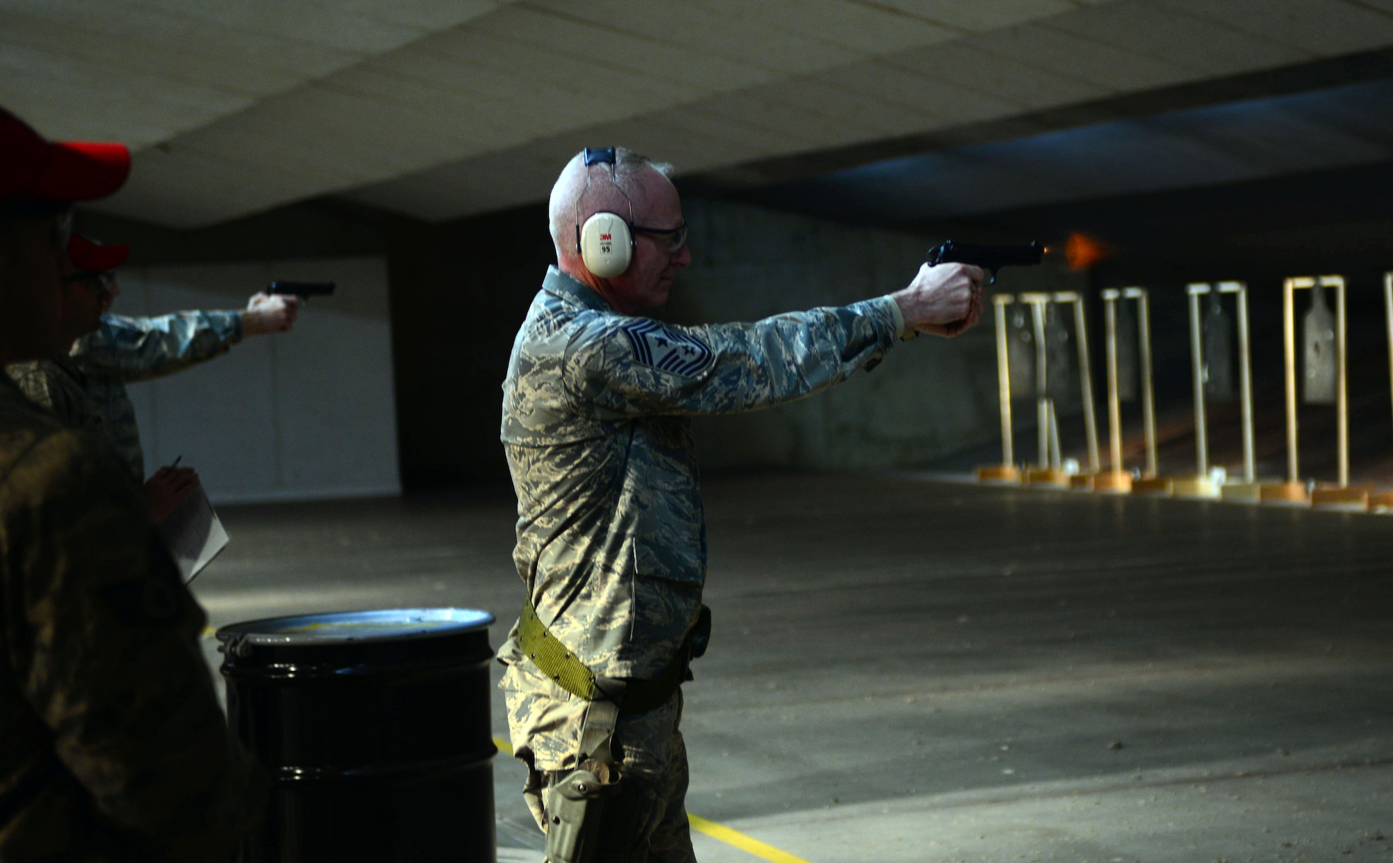 Chief Master Sgt. Alan Boling, command chief for the 8th Air Force, fires an M9 pistol at the Combat Arms Training and Maintenance facility during a visit to Ellsworth Air Force Base, S.D., March 9, 2017. CATM instructors are Security Forces members who train base personnel on the use of fire arms, while overseeing, maintaining and repairing all fire arms assigned to them. (U.S. Air Force photo by Airman 1st Class Donald C. Knechtel)