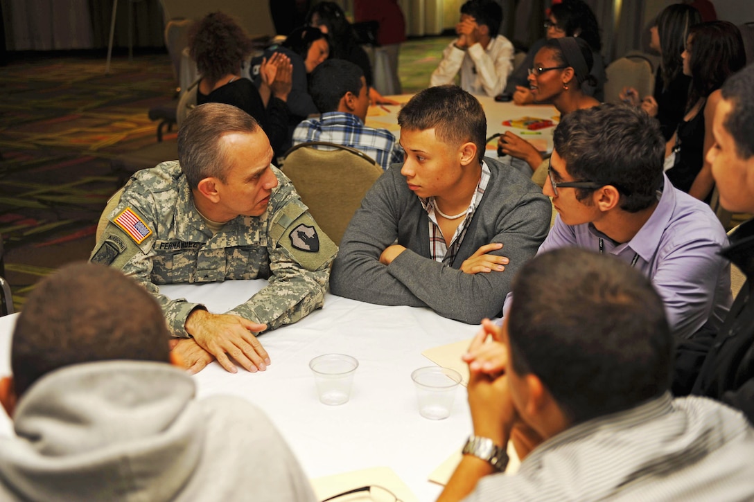Army Brig. Gen. Fernando Fernández talks with several teenagers