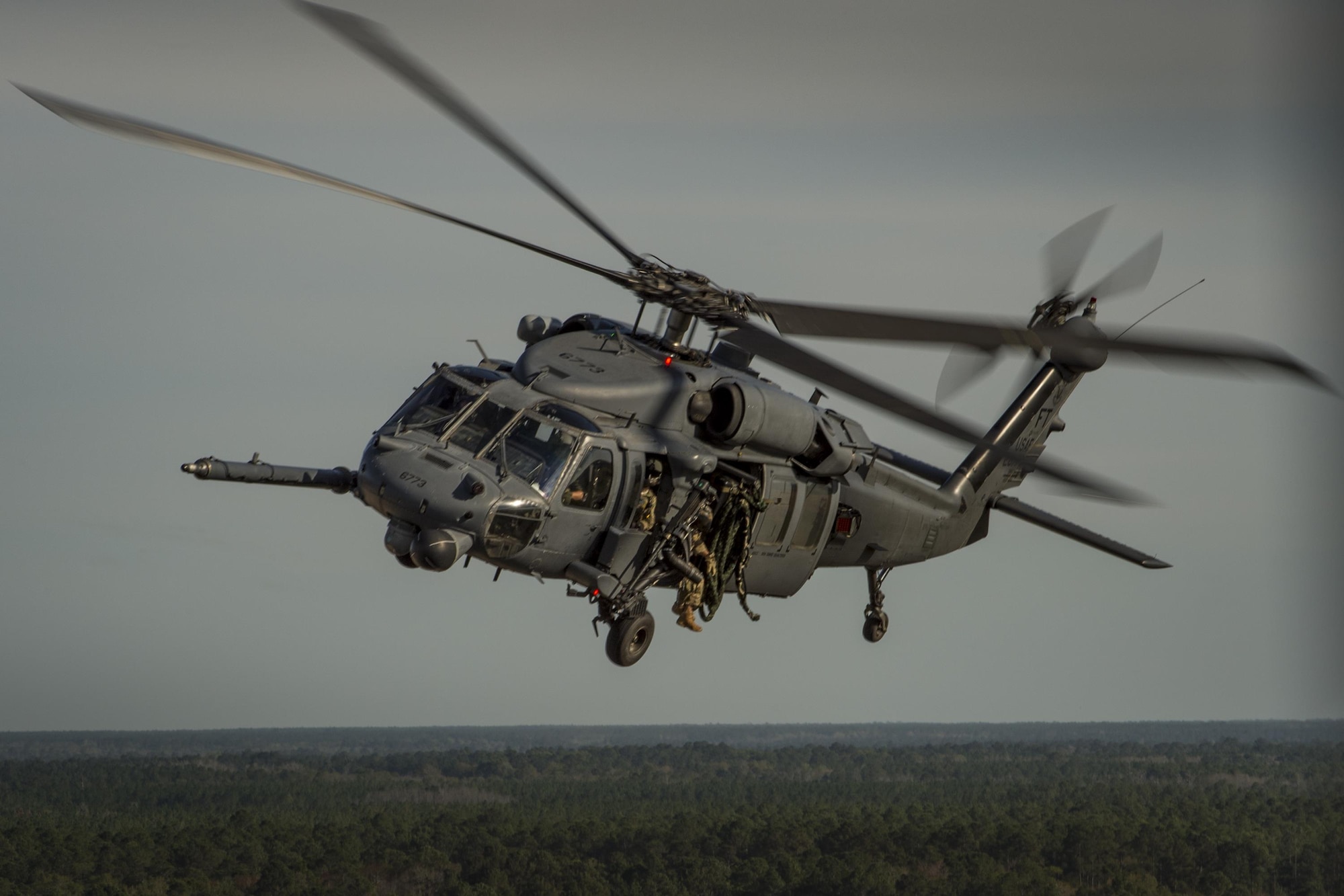An HH-60G Pave Hawk from the 41st Rescue Squadron, flies as part of a combat search and rescue demonstration during the 75th Anniversary Flying Tiger Reunion, March 10, 2017, at Moody Air Force Base, Ga. In 1941, President Roosevelt signed an executive order forming the American Volunteer Group. The AVG was organized into the 1st, 2nd, and 3rd Pursuit Squadrons and later disbanded and replaced by the 23d Fighter Group in 1942. Under the command of Gen. Claire Chennault, the Flying Tigers comprised of the 74th, 75th, and 76th Pursuit Squadrons defended China against the Japanese. Throughout World War II, the Flying Tigers achieved combat success and flew the US-made Curtiss P-40 Warhawks painted with the shark-mouth design. (U.S. Air Force photo by Tech. Sgt. Zachary Wolf)