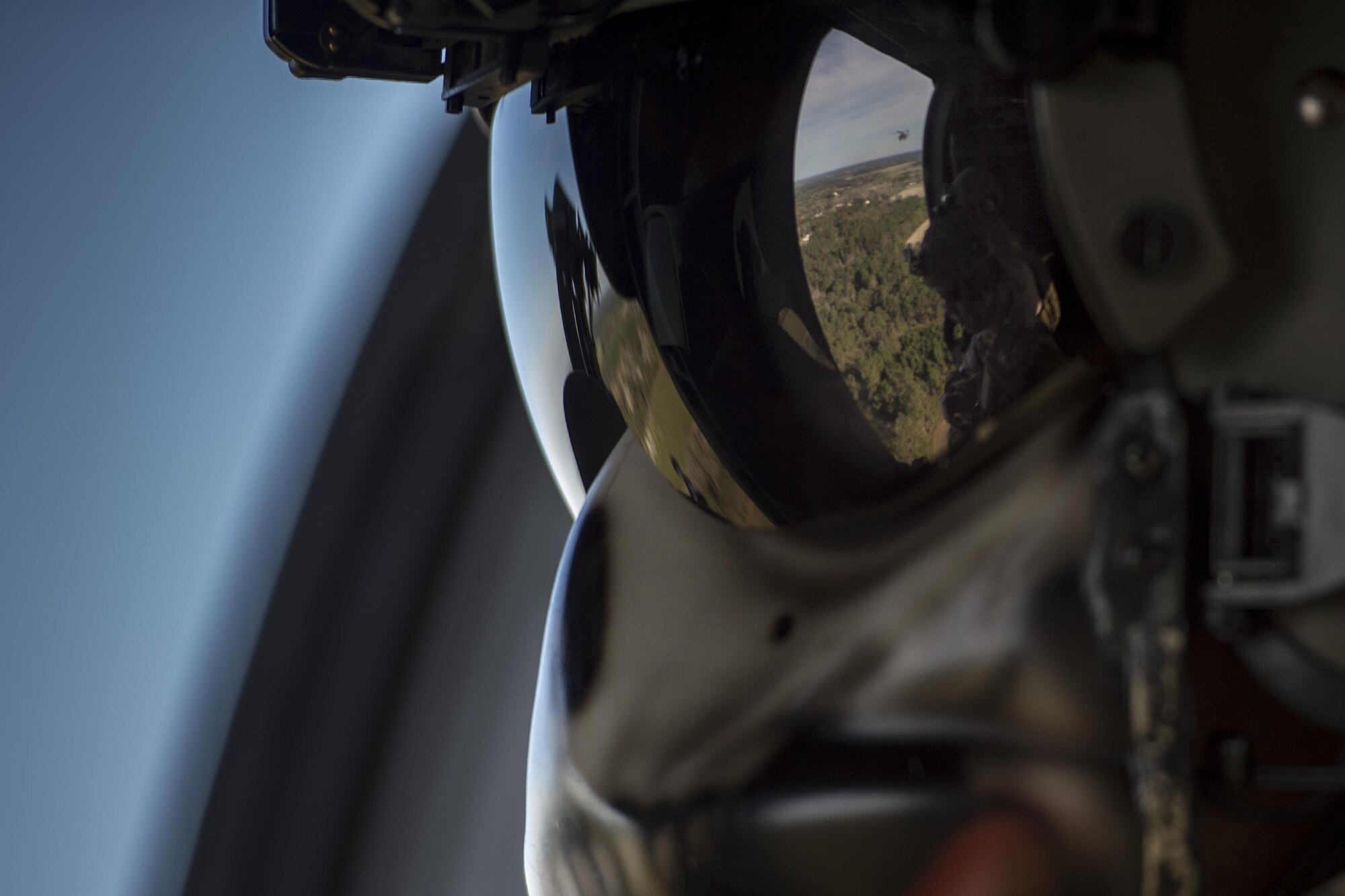 Staff Sgt. David Stringer, 41st Rescue Squadron special missions aviator, watches out of an HH-60G Pave Hawk during a combat search and rescue demonstration as one part of the 75th Anniversary Flying Tiger Reunion, March 10, 2017, at Moody Air Force Base, Ga. In 1941, President Roosevelt signed an executive order forming the American Volunteer Group. The AVG was organized into the 1st, 2nd, and 3rd Pursuit Squadrons and later disbanded and replaced by the 23d Fighter Group in 1942. Under the command of Gen. Claire Chennault, the Flying Tigers comprised of the 74th, 75th, and 76th Pursuit Squadrons defended China against the Japanese. Throughout World War II, the Flying Tigers achieved combat success and flew the US-made Curtiss P-40 Warhawks painted with the shark-mouth design. (U.S. Air Force photo by Tech. Sgt. Zachary Wolf)
