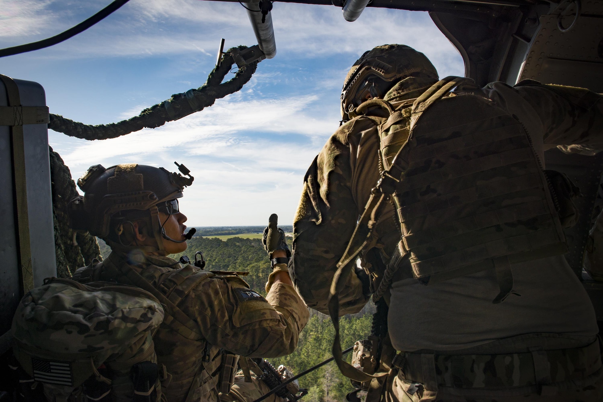 Pararescuemen from the 38th Rescue Squadron prepare to fast-rope from an HH-60G Pave Hawk as part of a combat search and rescue demonstration during the 75th Anniversary Flying Tiger Reunion, March 10, 2017, at Moody Air Force Base, Ga. In 1941, President Roosevelt signed an executive order forming the American Volunteer Group. The AVG was organized into the 1st, 2nd, and 3rd Pursuit Squadrons and later disbanded and replaced by the 23d Fighter Group in 1942. Under the command of Gen. Claire Chennault, the Flying Tigers comprised of the 74th, 75th, and 76th Pursuit Squadrons defended China against the Japanese. Throughout World War II, the Flying Tigers achieved combat success and flew the US-made Curtiss P-40 Warhawks painted with the shark-mouth design. (U.S. Air Force photo by Staff Sgt. Ryan Callaghan)