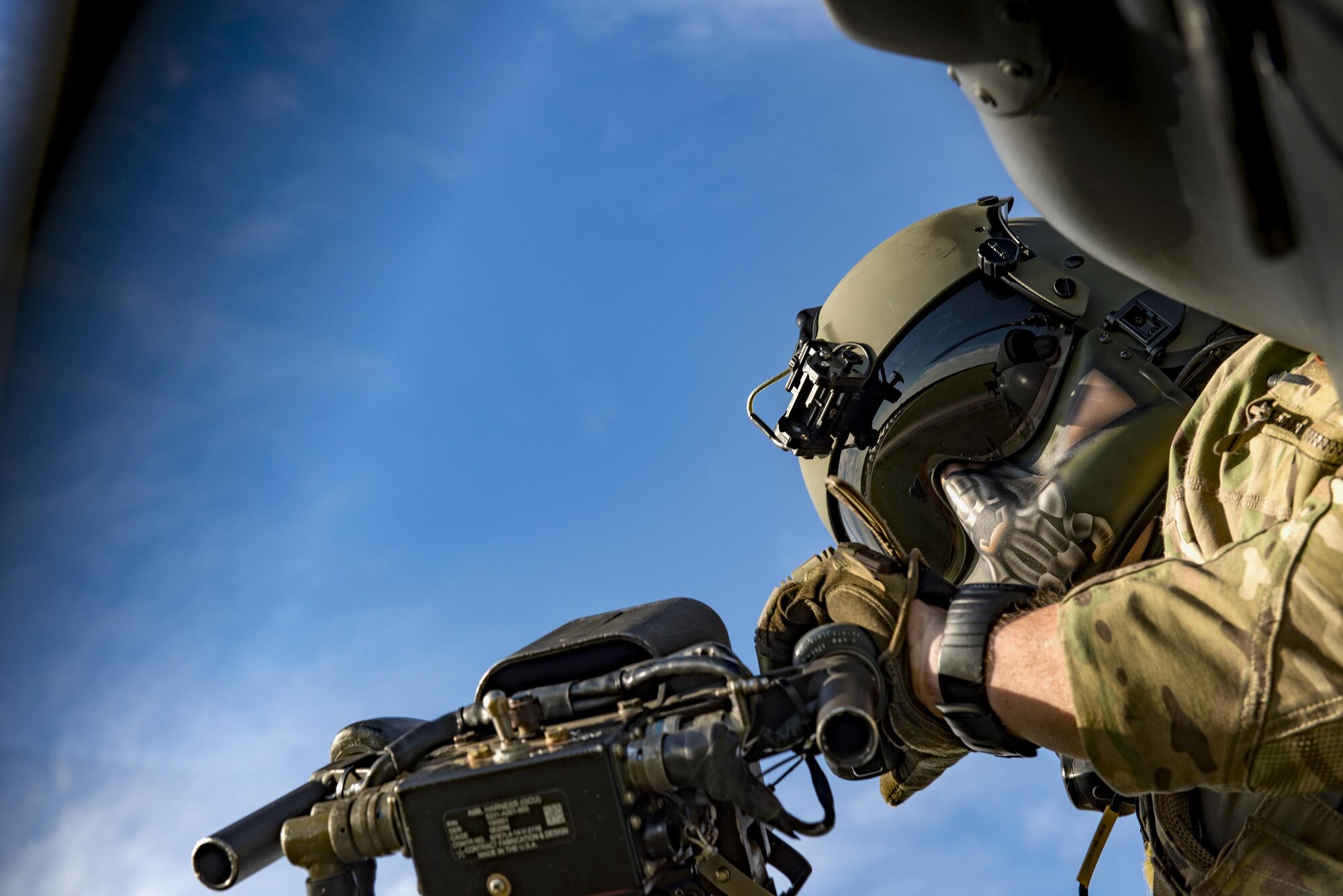 Tech. Sgt. Paul Hiller, 41st Rescue Squadron special missions aviator, scans the landscape below as part of a combat search and rescue demonstration during the 75th Anniversary Flying Tiger Reunion, March 10, 2017, at Moody Air Force Base, Ga. In 1941, President Roosevelt signed an executive order forming the American Volunteer Group. The AVG was organized into the 1st, 2nd, and 3rd Pursuit Squadrons and later disbanded and replaced by the 23d Fighter Group in 1942. Under the command of Gen. Claire Chennault, the Flying Tigers comprised of the 74th, 75th, and 76th Pursuit Squadrons defended China against the Japanese. Throughout World War II, the Flying Tigers achieved combat success and flew the US-made Curtiss P-40 Warhawks painted with the shark-mouth design. (U.S. Air Force photo by Staff Sgt. Ryan Callaghan)