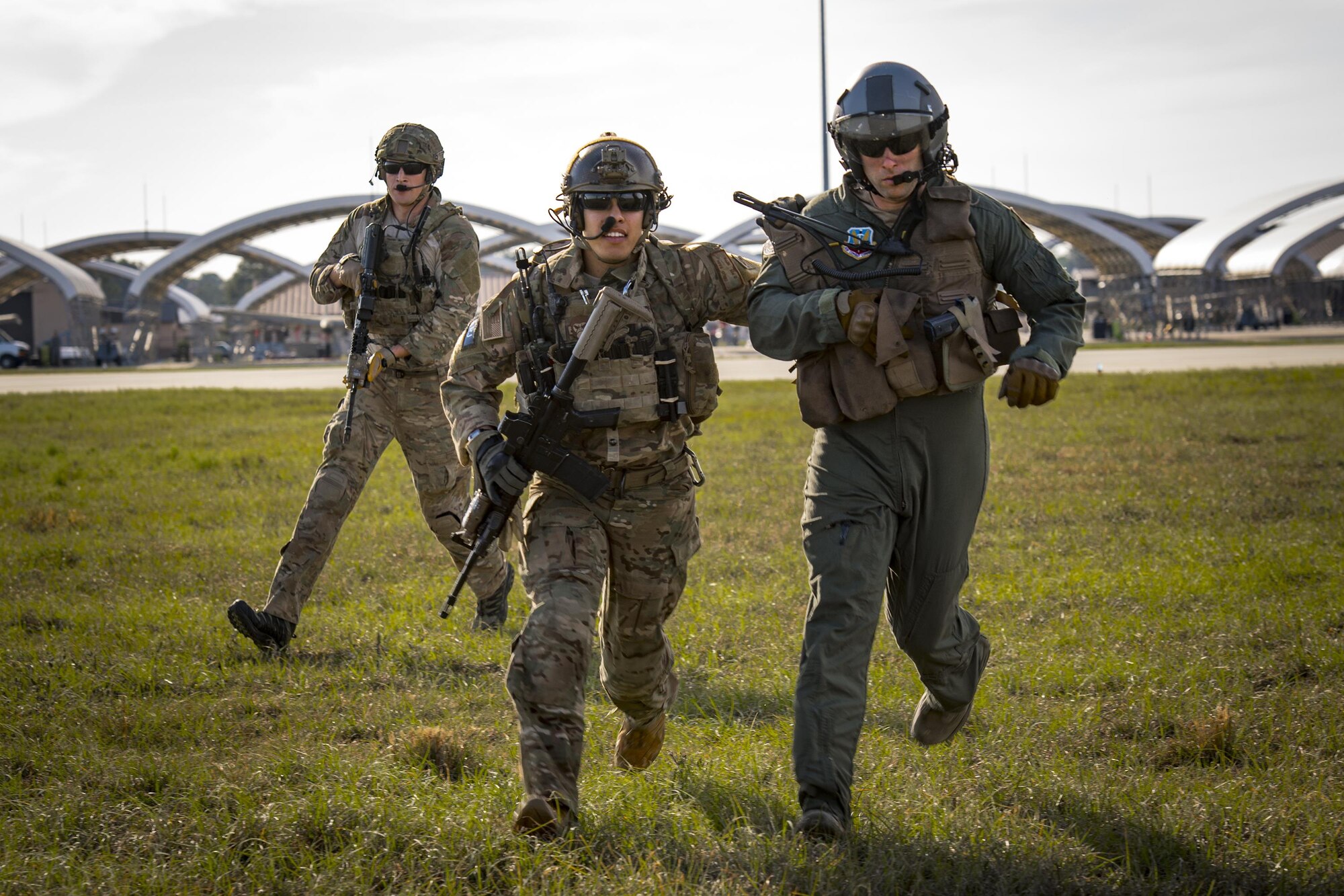 Pararescuemen from the 38th Rescue Squadron bring an isolated pilot into an HH-60G Pave Hawk as part of a combat search and rescue demonstration during the 75th Anniversary Flying Tiger Reunion, March 10, 2017, at Moody Air Force Base, Ga. In 1941, President Roosevelt signed an executive order forming the American Volunteer Group. The AVG was organized into the 1st, 2nd, and 3rd Pursuit Squadrons and later disbanded and replaced by the 23d Fighter Group in 1942. Under the command of Gen. Claire Chennault, the Flying Tigers comprised of the 74th, 75th, and 76th Pursuit Squadrons defended China against the Japanese. Throughout World War II, the Flying Tigers achieved combat success and flew the US-made Curtiss P-40 Warhawks painted with the shark-mouth design. (U.S. Air Force photo by Staff Sgt. Ryan Callaghan)