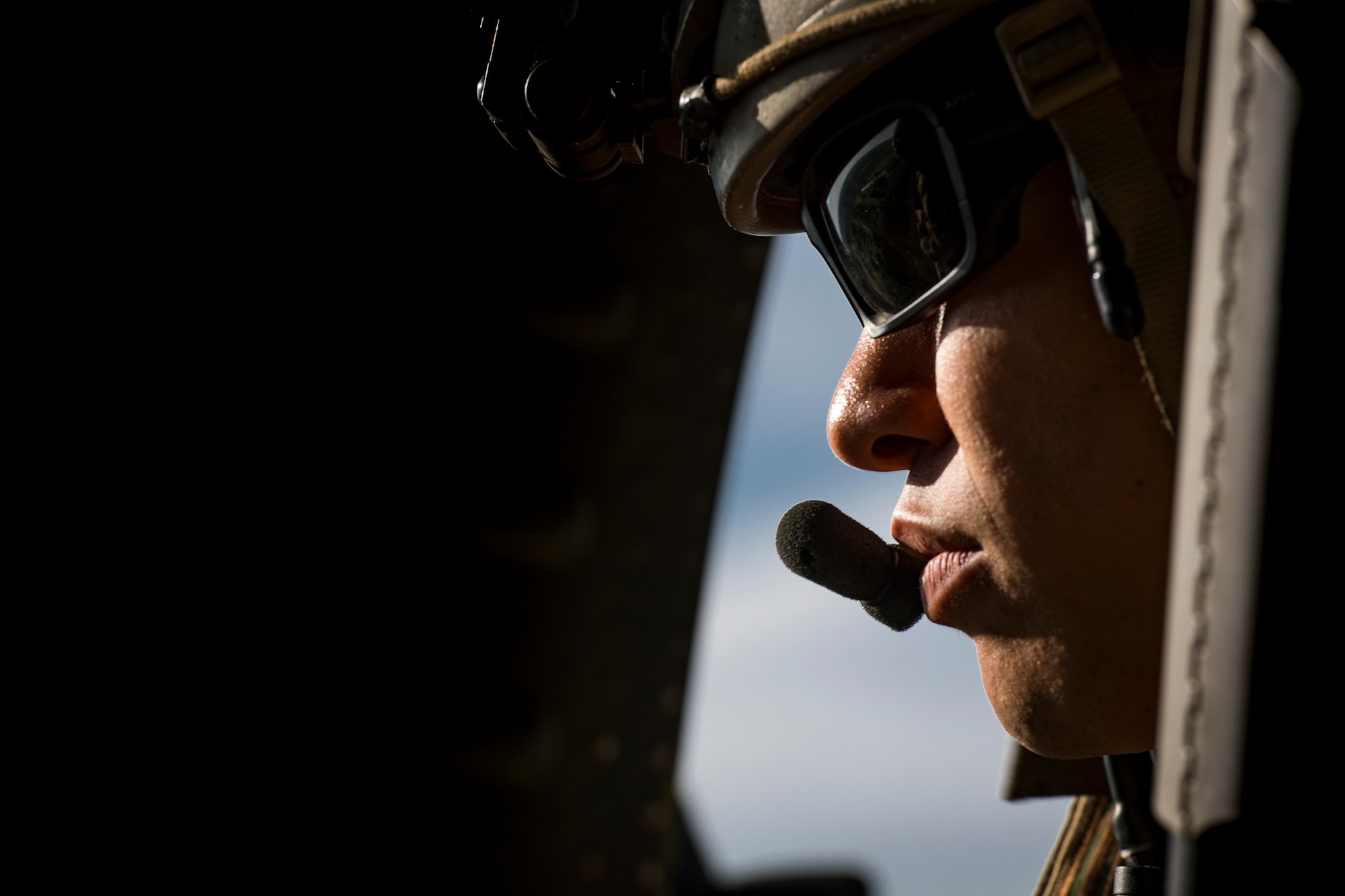 A Pararescueman from the 38th Rescue Squadron looks out the window of an HH-60G Pave Hawk following a combat search and rescue demonstration during the 75th Anniversary Flying Tiger Reunion, March 10, 2017, at Moody Air Force Base, Ga. In 1941, President Roosevelt signed an executive order forming the American Volunteer Group. The AVG was organized into the 1st, 2nd, and 3rd Pursuit Squadrons and later disbanded and replaced by the 23d Fighter Group in 1942. Under the command of Gen. Claire Chennault, the Flying Tigers comprised of the 74th, 75th, and 76th Pursuit Squadrons defended China against the Japanese. Throughout World War II, the Flying Tigers achieved combat success and flew the US-made Curtiss P-40 Warhawks painted with the shark-mouth design. (U.S. Air Force photo by Staff Sgt. Ryan Callaghan)