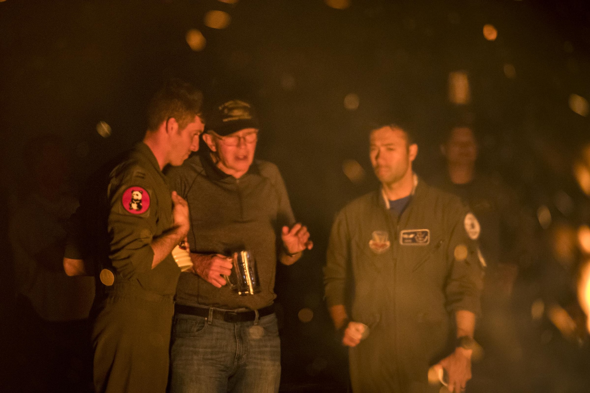 A-10C Thunderbolt II pilots from the 23d Fighter Group speak with a former member of the Flying Tigers at a piano burn during the 75th Anniversary Flying Tiger Reunion, March 10, 2017, at Moody Air Force Base, Ga. In 1941, President Roosevelt signed an executive order forming the American Volunteer Group. The AVG was organized into the 1st, 2nd, and 3rd Pursuit Squadrons and later disbanded and replaced by the 23d Fighter Group in 1942. Under the command of Gen. Claire Chennault, the Flying Tigers comprised of the 74th, 75th, and 76th Pursuit Squadrons defended China against the Japanese. Throughout World War II, the Flying Tigers achieved combat success and flew the US-made Curtiss P-40 Warhawks painted with the shark-mouth design. (U.S. Air Force photo by Staff Sgt. Ryan Callaghan)