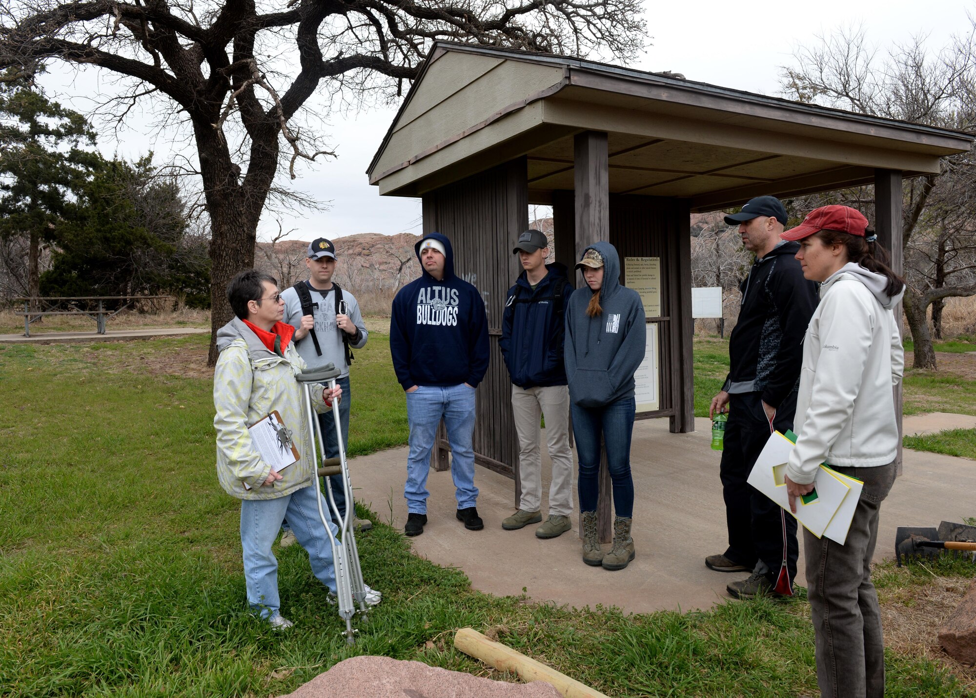 Airmen from the 97th Training Squadron receive instruction on clearing a trail, at Quartz Mountain Nature Park, Oklahoma, March 11, 2017. 97th TRS Airmen cleared trails of brush and debris to help beautify the Quartz Mountain Nature Park and make it safer for the community. (U.S. Air Force Photo by Airman 1st Class Jackson N. Haddon/Released).