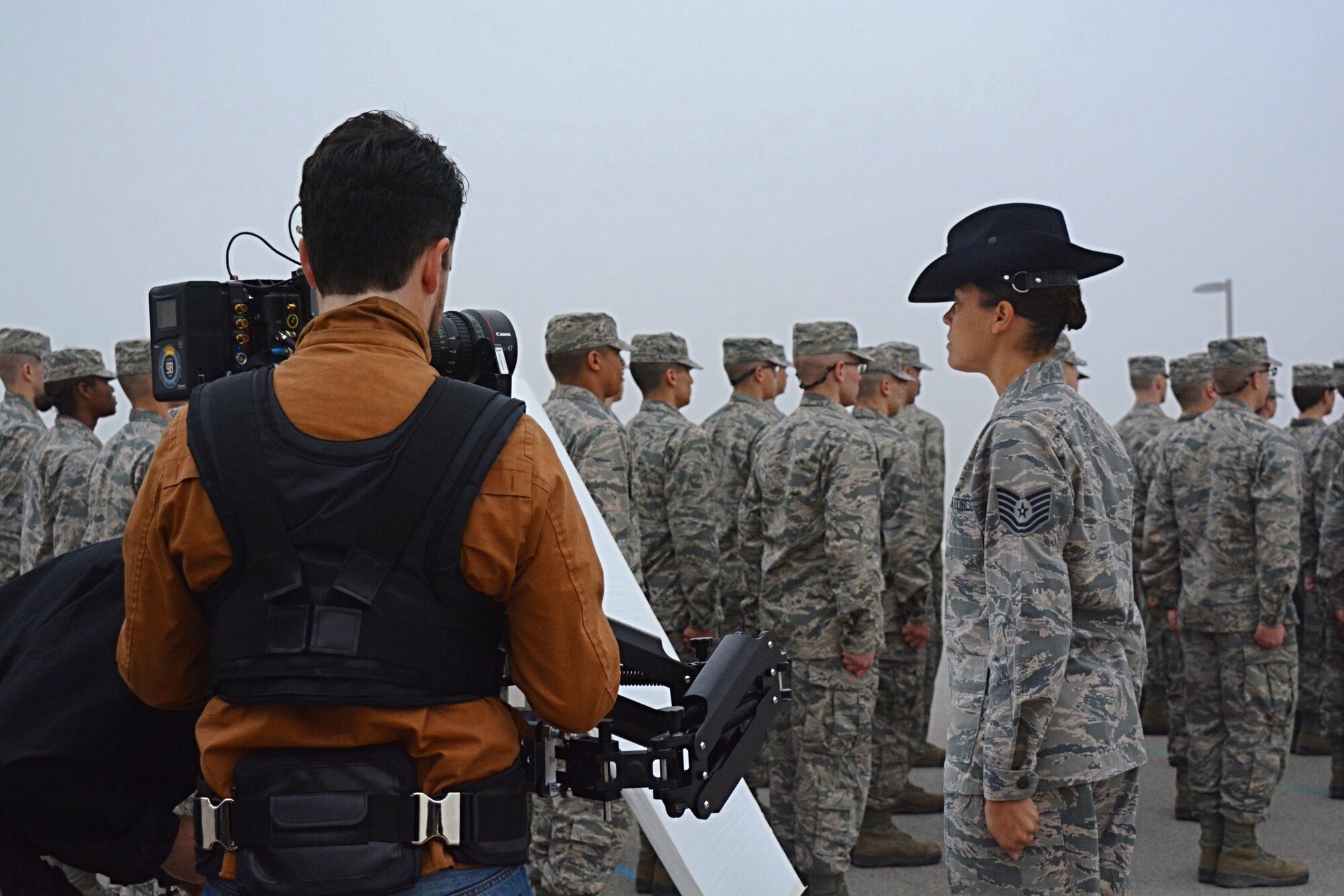 Tech. Sgt. Serenna Harmon, a Basic Military Instructor at Joint Base San Antonio-Lackland, Texas, pushes a flight of trainees as a film crew captures the action. Harmon was selected to participate in the Profession of Arms Center of Excellence’s newest Heritage Today video that focuses on Air Education and Training Command. Filming was conducted over two days around Joint Base San Antonio in early February and features a number of military and civilians in instructor and training positions. (U.S. Air Force photo by Christa D’Andrea)