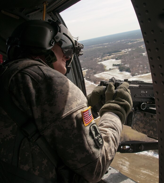 An Army Reserve crew chief, assigned to 8th Battalion, 229th Aviation Regiment, based out of Fort Knox, Ky., scans his sector of fire from a UH-60 Black Hawk Helicopter above Lakehurst Maxfield Field during a multi-component airfield seizure training exercise between the Army Reserve and the 101st Airborne Division on March 13, 2017 to kick off Warrior Exercise 78-17-01. Several Army Reserve organizations including the Army Reserve Aviation Command, 84th Training Command, 78th Training Division, and members of the 200th Military Police Command helped Easy Company, 2nd Battalion, 506th Parachute Infantry Regiment, 101st Airborne Division conduct the mission. Roughly 60 units from the U.S. Army Reserve, U.S. Army, U.S. Air Force, and Canadian Armed Forces are participating in the 84th Training Command’s joint training exercise, WAREX 78-17-01, at Joint Base McGuire-Dix-Lakehurst from March 8 until April 1, 2017; the WAREX is a large-scale collective training event designed to assess units’ combat capabilities as America’s Army Reserve continues to build the most capable, combat-ready, and lethal Federal Reserve force in the history of the Nation.