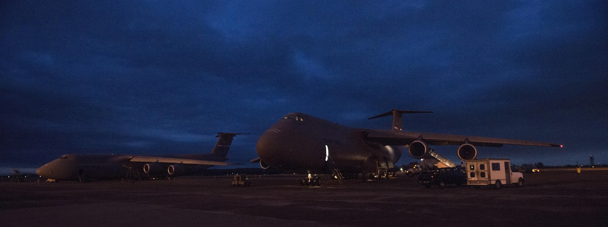 Two C-5 Super Galaxies from Travis Air Force Base, Calif., sit on the ramp March 7, 2017, at Yokota Air Base, Japan. The C-5Ms are participating in a Pacific channel mission, flying to Japan and South Korea to deliver various cargo throughtout the Pacific region. (U.S. Air Force photo/Staff Sgt. Nicole Leidholm)