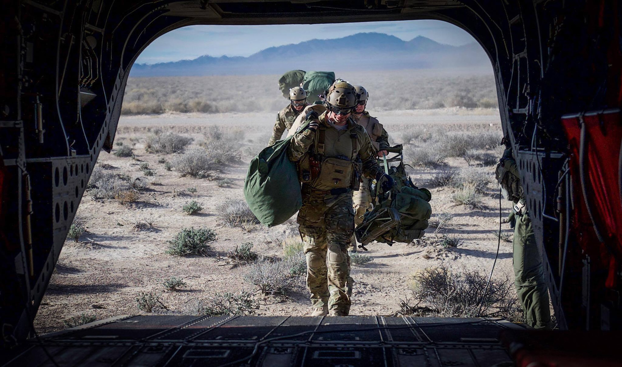 Survival, Evasion, Resistance, and Escape (SERE) specialist are picked up by a CH-47 Chinook after performing static-line jumps on the Nevada Test and Training Range, during Red Flag 17-2, March 7, 2017. SERE specialists lead the Air Force emergency parachuting program and conduct extensive testing of parachuting systems. They are uniquely suited to analyze the operating environment to plan for evasion, captivity, and recovery considerations. (U.S. Air Force photo by Airman 1st Class Kevin Tanenbaum/Released)