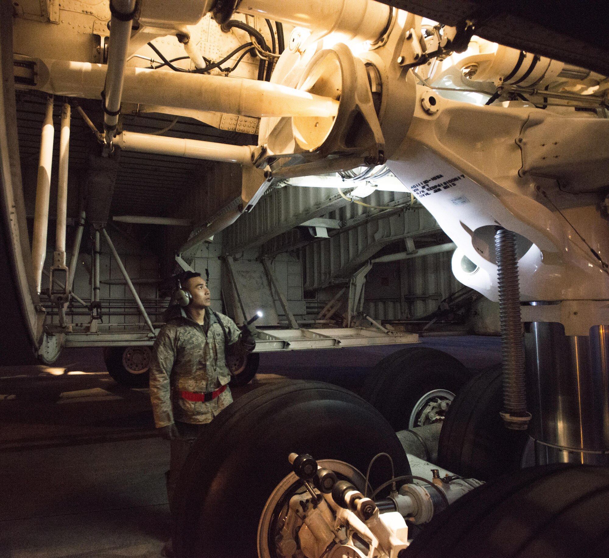Staff Sgt. Piere Manivong, 22nd AS, completes a pre-flight inspection of a C-5M Super Galaxy landing gear prior to a flight March 7, 2017 from Yokota Air Base, Japan, to Osan Air Base, South Korea. As a flight engineer, Manivong is responsible for completing pre-flight inspections of the aircraft prior to the pilots coming on board to ensure everything is safe for the flight. (U.S. Air Force photo by Staff Sgt. Nicole Leidholm)