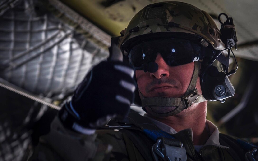 A Survival, Evasion, Resistance, and Escape specialist gives the thumbs up before performing a static-line jump during Red Flag 17-2 over the Nevada Test and Training Range, March 7, 2017. Search and rescue operations during Red Flag improve efficiency and readiness for future real world operations. (U.S. Air Force photo by Airman 1st Class Kevin Tanenbaum/Released)