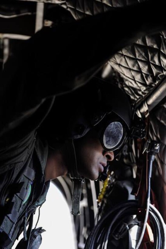 A Singapore air force crew chief looks out the window of a CH-47 Chinook before Survival, Evasion, Resistance, and Escape specialist perform static-line jumps over the Nevada Test and Training Range, during Red Flag 17-2, March 7, 2017. Flying units from around the globe deploy to Nellis Air Force Base, Nev., to participate in Red Flag. (U.S. Air Force photo by Airman 1st Class Kevin Tanenbaum/Released)