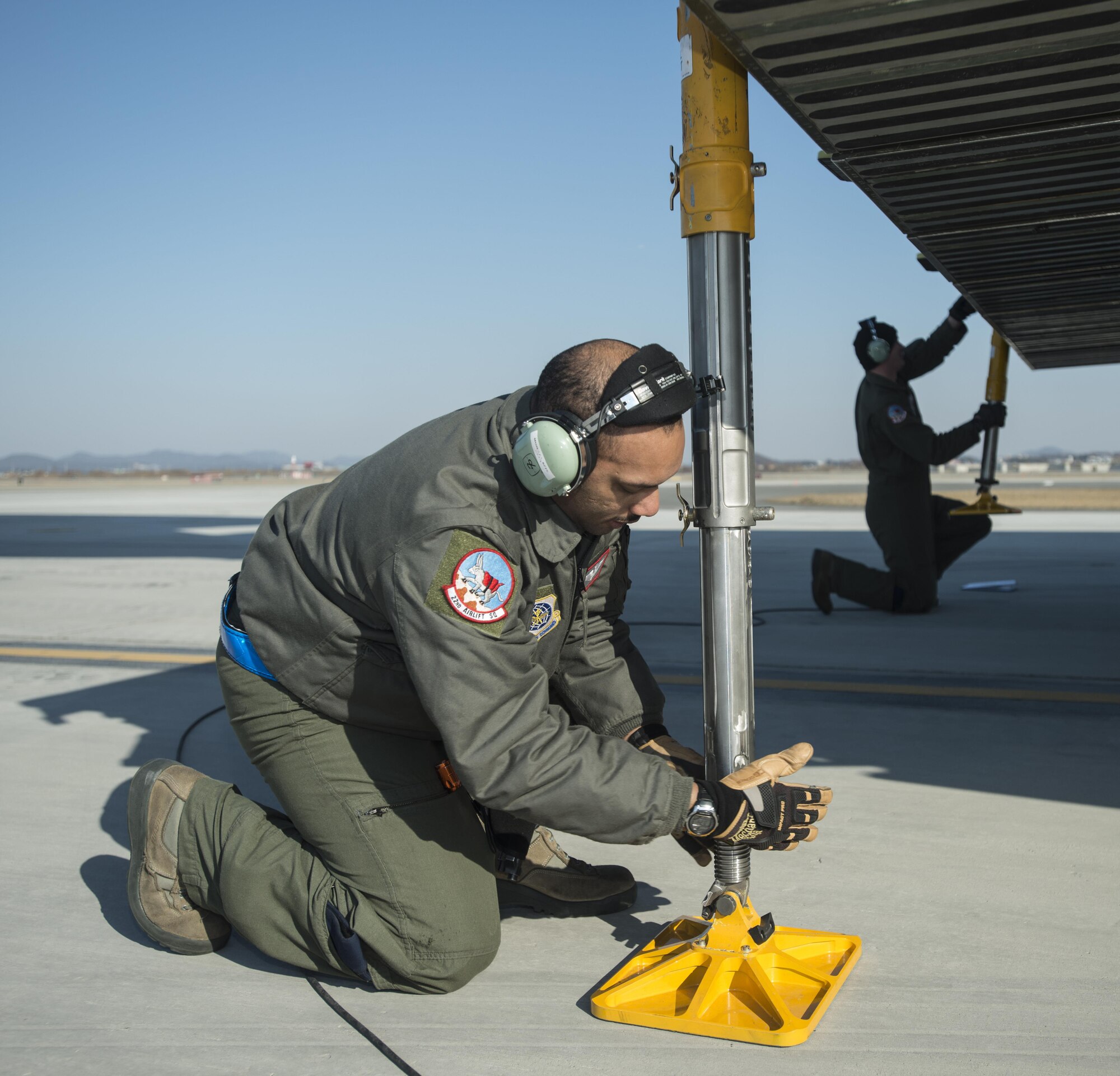 Staff Sgt. Jarryd Morgan, left, and Staff Sgt. Matthew Larson, assigned to the Airlift Squadron, set support jacks for a C-5M Super Galaxy in preparation to offload cargo through the forward ramp doors March 7, 2017 at Osan Air Base, South Korea. While at Osan AB, the loadmasters offloaded nearly 70,000 pounds of cargo. (U.S. Air Force photo by Staff Sgt. Nicole Leidholm)