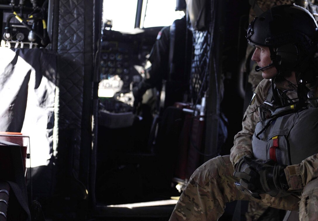 A Survival, Evasion, Resistance, and Escape (SERE) specialist, sits on a CH-47 Chinook before performing a static-line jump over the Nevada Test and Training Range, during Red Flag 17-2, March 7, 2017. A static line is a fixed cord attached to a large, stable object and is used to open parachutes automatically. (U.S. Air Force photo by Airman 1st Class Kevin Tanenbaum/Released)