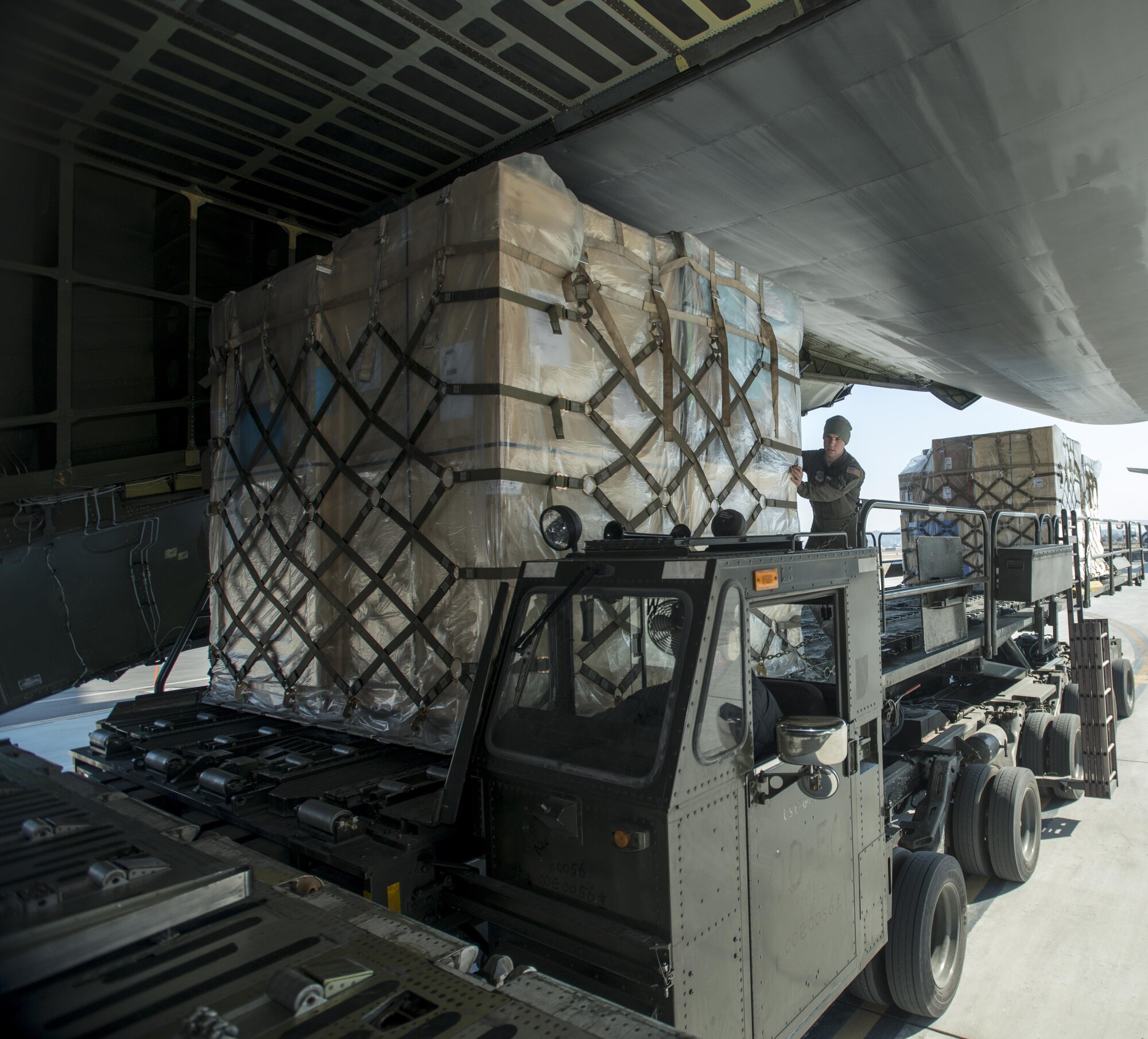 Senior Airman Elias Wilson, 22nd Airlift Squadron, loads pallets of household goods March 7, 2017, at Osan Air Base, South Korea. A total of 14 pallets of household goods were returned back to the United States for service members who are being reassigned duty stations. (U.S. Air Force photo by Staff Sgt. Nicole Leidholm)