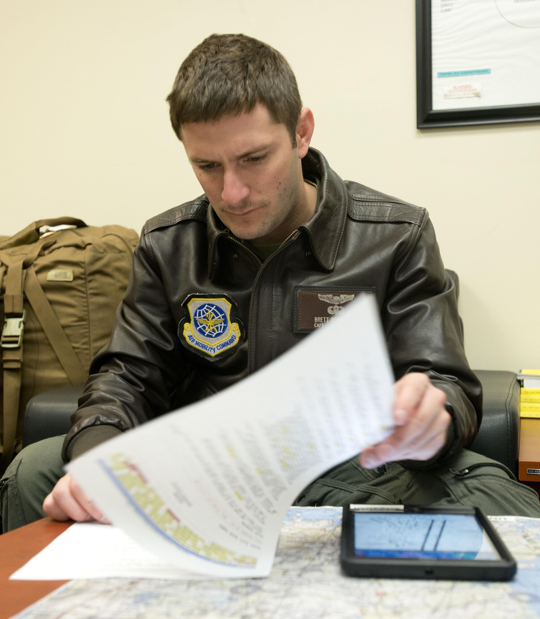Capt. Brett Boudreaux, 22nd Airlift Squadron, goes over the flight plan March 9, 2017, for the day's mission from Osan Air Base, South Korea, to Yokota Air Base, Japan. Boudreaux was on a Pacific channel mission, flying cargo from Osan AB to Travis Air Force Base, Calif. (U.S. Air Force photo by Staff Sgt. Nicole Leidholm)