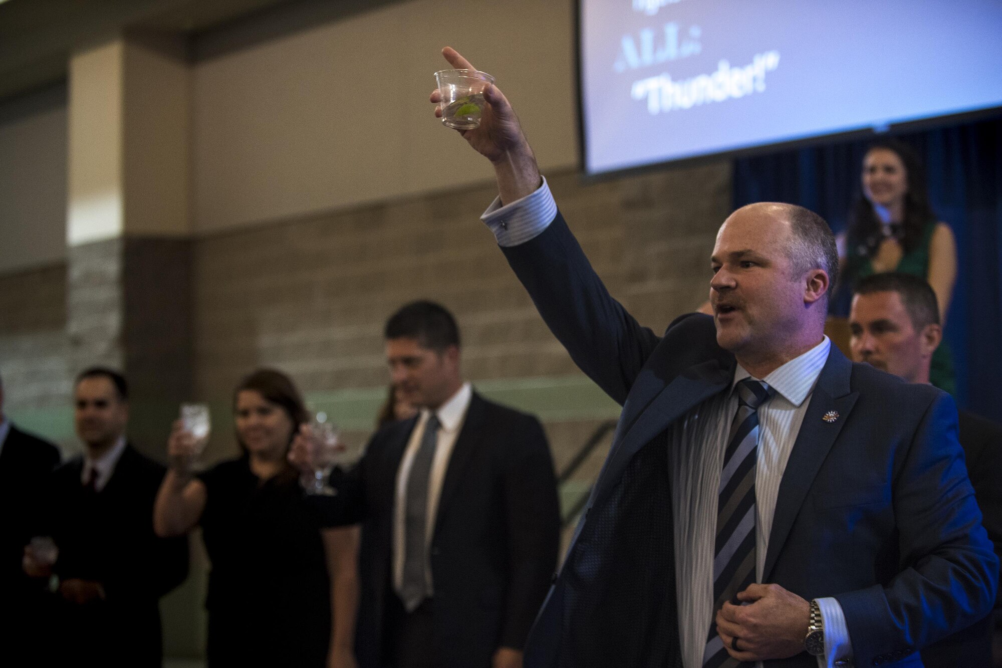 Lt. Col. Bryon France, 74th Fighter Squadron commander, makes a toast to the Flying Tigers past and present during the 75th Anniversary Flying Tiger Reunion, March 10, 2017, at Moody Air Force Base, Ga. In 1941, President Roosevelt signed an executive order forming the American Volunteer Group. The AVG was organized into the 1st, 2nd, and 3rd Pursuit Squadrons and later disbanded and replaced by the 23d Fighter Group in 1942. Under the command of Gen. Claire Chennault, the Flying Tigers comprised of the 74th, 75th, and 76th Pursuit Squadrons defended China against the Japanese. Throughout World War II, the Flying Tigers achieved combat success and flew the US-made Curtiss P-40 Warhawks painted with the shark-mouth design. (U.S. Air Force photo by Andrea Jenkins)