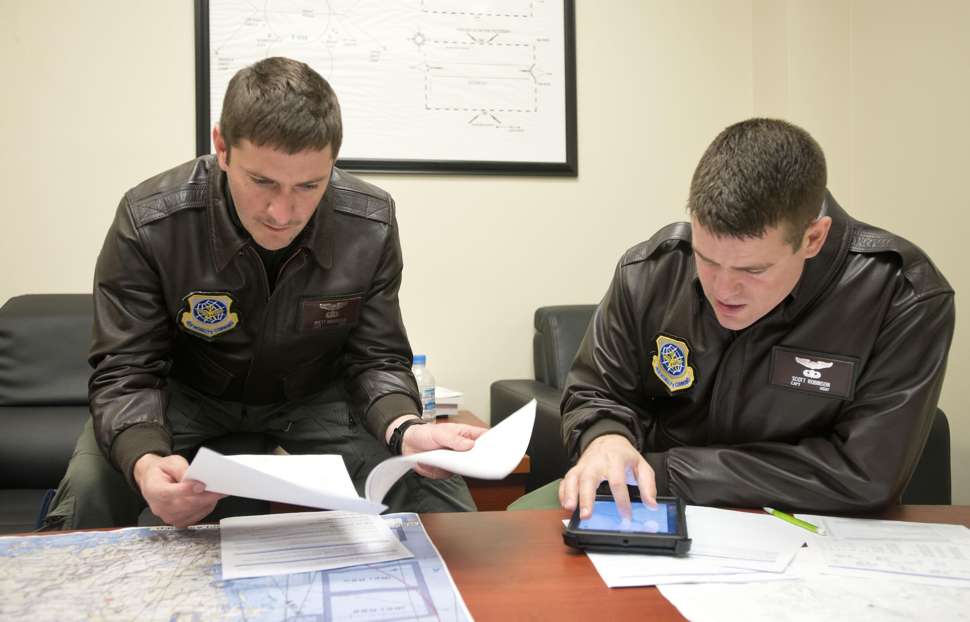 Capt. Brett Boudreaux, left, and Capt. Scott Robinson, assigned to the 22nd Airlift Squadron, go over the flight plan March 9, 2017, for the day's mission from Osan Air Base, South Korea, to Yokota Air Base, Japan. The pilots were on what's called a Pacific channel mission, flying cargo from Osan AB to Travis Air Force Base, California. (U.S. Air Force photo by Staff Sgt. Nicole Leidholm)