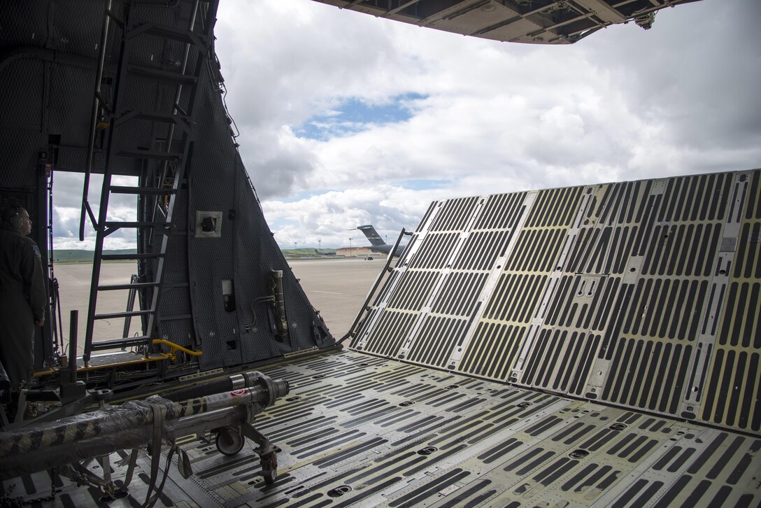 Tech. Sgt. Isaac Nunez, 60th Aircraft Maintenance Squadron, closes the forward ramp extension and visor prior to a departure March 4, 2017, for Yokota Air Base, Japan. Nunez, along with members of the 22nd Airlift Squadron flew a Pacific channel mission to Yokota AB and Osan AB, South Korea, delivering cargo and space-available passengers. (U.S. Air Force photo by Staff Sgt. Nicole Leidholm)