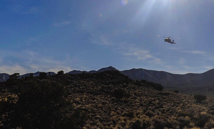 A Navy UH-60 Blackhawk flies over the Nevada Test and Training Range, looking for a downed pilot during a Red Flag 17-2 combat search and rescue mission, March 8, 2017. A CSAR mission may be carried out by a task force of helicopters, ground-attack aircraft, aerial refueling tankers and an airborne command post. (U.S. Air Force photo by Airman 1st Class Kevin Tanenbaum/Released)