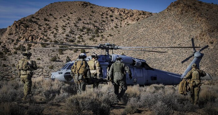 Pararescuemen carry a simulated downed pilot to a U.S. Navy UH-60 Blackhawk during a Red Flag 17-2 combat search and rescue mission on the Nevada Test and Training Range, March 8, 2017. The mission of pararescue is to rescue, recover, and return American or Allied forces in times of danger or extreme duress. (U.S. Air Force photo by Airman 1st Class Kevin Tanenbaum/Released)