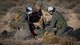 Pararescuemen examine a simulated downed pilot during a Red Flag 17-2 combat search and rescue mission on the Nevada Test and Training Range, March 8, 2017. Red Flag provides combat training in a degraded and operationally limited environment making the training missions as realistic as possible. (U.S. Air Force photo by Airman 1st Class Kevin Tanenbaum/Released)