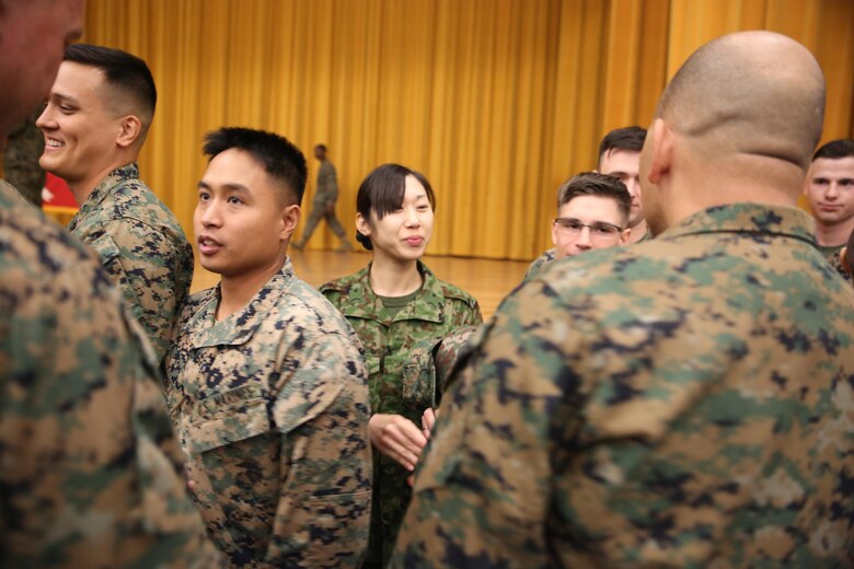 Japan Ground Self-Defense Force Sgt. Mizuho Ban greets service members while being congratulated after graduating Corporal’s Course Feb. 10 aboard Camp Foster, Okinawa, Japan. Ban attended the Corporal’s Course aboard Camp Foster with Marines, sailors and airmen. Ban has been in the JGSDF for eight years, and is a radio communicator with 1st Electronic Warfare Unit, 2nd Direction Finding Company.