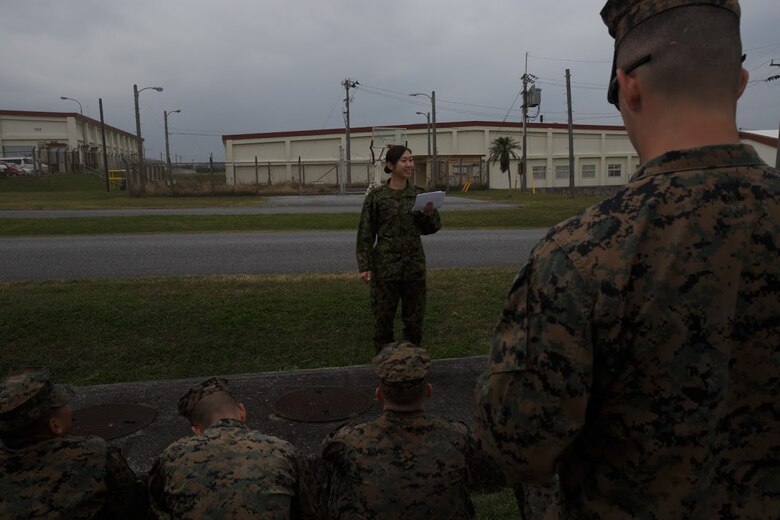 Japan Ground Self-Defense Force Sgt. Mizuho Ban gives a speach during Corporal’s Course Feb. 8 at Marine Corps Air Station Futenma, Okinawa, Japan. During the course, service members learn a variety of leadership tools, such as public speaking, and are graded on their performance. Ban has been in the JGSDF for eight years, and is a radio communicator with 1st Electronic Warfare Unit, 2nd Direction Finding Company.