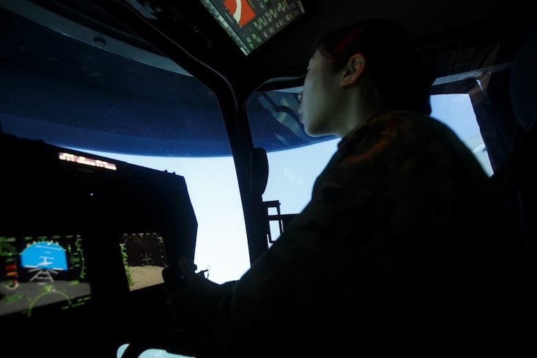 Japan Ground Self-Defense Force Sgt. Mizuho Ban experiences flying the MV-22B Osprey tiltrotor aircraft in a flight simulator during Corporal’s Course Feb. 8 at Marine Corps Air Station Futenma, Okinawa, Japan. Ban, a radio communicator with 1st Electronic Warfare Unit, 2nd Direction Finding Company, has been in the JGSDF for eight years. 