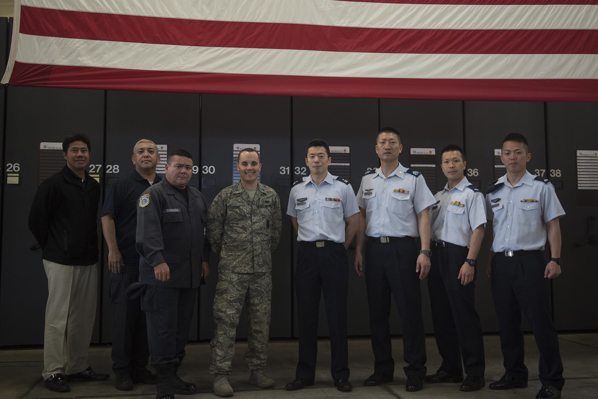 Members of the Japan Air Self-Defense Force pose with members of the Security Forces Squadron during a tour March. 14, 2017, at Kadena Air Base, Japan. The JASDF members received a tour of the squadron as well as a demonstration from the military working dogs. (U.S. Air Force photo by Airman 1st Class Corey Pettis/Released)