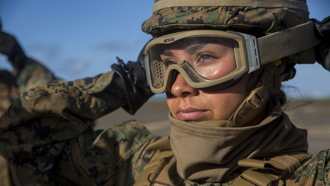 Lance Cpl. Loren Brooks, a motor transport specialist with Transportation Services Company, Combat Logistics Battalion 3, adjusts her goggles during external lift training at Landing Zone West Field at Marine Corps Air Station Kaneohe Bay, Hawaii, March 8, 2017. Landing support specialists with TSC partnered with Marine Heavy Helicopter Squadron 463 to conduct external load lifts. This training improves proficiency for the pilots when moving supplies while Marines on the ground conditioned themselves to safely prepare dual and single load lifts.