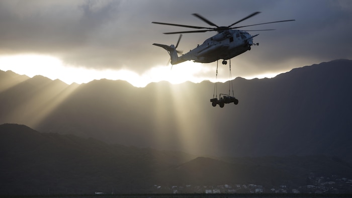 A CH-53E Super Stallion helicopter assigned to Marine Heavy Helicopter Squadron 463, carries a Humvee during an external lift training at Landing Zone West Field at Marine Corps Air Station Kaneohe Bay, Hawaii, March 8, 2017. This training improves proficiency for the pilots when moving supplies while Marines on the ground conditioned themselves to safely prepare dual and single load lifts.