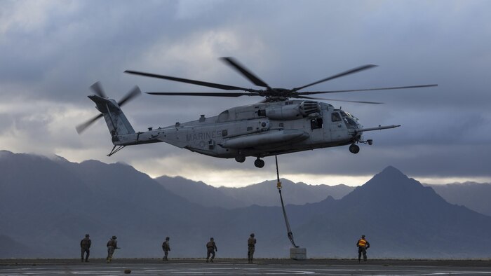 Marines with Transportation Services Company, Combat Logistics Battalion 3 and Marine Heavy Helicopter Squadron 463 conduct external lift training at Landing Zone West Field at Marine Corps Air Station Kaneohe Bay, Hawaii, March 8, 2017. This training improves proficiency for the pilots when moving supplies while Marines on the ground conditioned themselves to safely prepare dual and single load lifts.