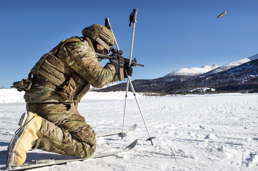Air Force Senior Airman Daniel Gonzales uses ski poles for support while firing an M4 carbine rifile during Arctic live-fire training at Joint Base Elmendorf-Richardson, Alaska, March 7, 2017. Gonzales is tactical air control party member assigned to the 3rd Air Support Operations Squadron. Air Force photo by Alejandro Pena