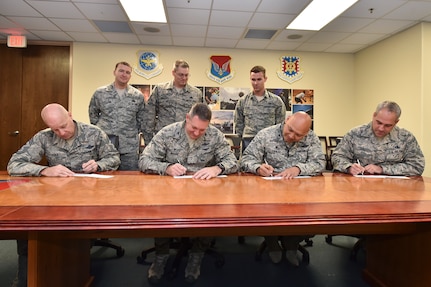 U.S. Air Force Col. Robert Lyman, 628th Air Base Wing commander, left-center, with Chief Master Sgt. Todd Cole, 628th Air Base Wing command chief, left, Col. Jimmy Canlas, 437th Airlift Wing commander, right-center, Chief Master Sgt. Kristopher Berg, 437th Airlift Wing command chief, right, donate to the Air Force Assistance Fund March 13, 2017 at Joint Base Charleston. The AFAF campaign is a fundraising event taking place from March 6 through April 14, 2017 here. During this time, money will be raised through various fundraising events. The large thermometer signs located on base indicate the progress toward reaching this year’s goal of $50,950 and 100 percent contact. 