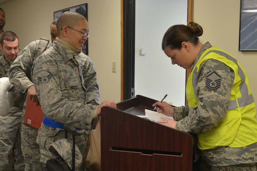 Master Sgt. Marlena Lugo Ruiz, 5th Force Support Squadron career development element NCO in charge, takes accountability during a deployment processing line at Minot Air Force Base, N.D., March 9, 2017.  (U.S. Air Force photo/Airman 1st Class Jessica Weissman)