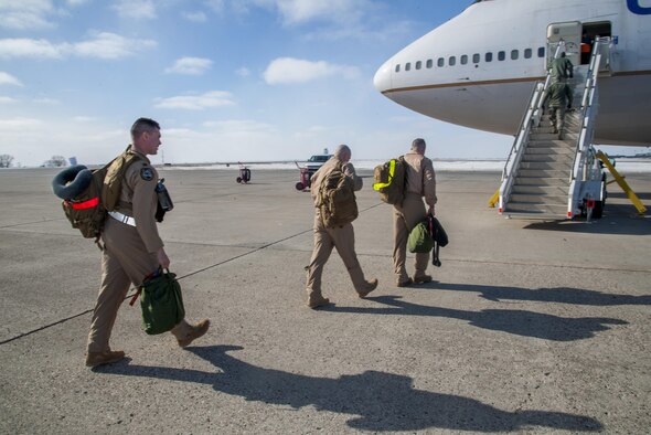 Minot Airmen board a plane during a mass deployment at Minot Air Force Base, N.D., March 9, 2017. Airmen deploy to assure allies, deter adversaries and defeat our enemies. (U.S. Air Force photo/Senior Airman Christian Sullivan)