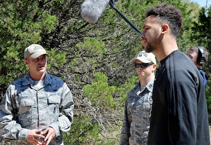 Kyle Anderson of the San Antonio Spurs gets a briefing on what security forces trainees experience during training at Joint Base San Antonio-Camp Bullis March 14.