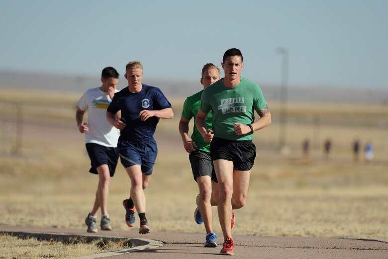 Team Schriever members run the trail during the annual St. Paddy’s Day run at Schriever Air Force Base, Colorado, Wednesday, March 8, 2017. The Schriever Fitness Center sponsored the event and gave T-shirts and pedometers to participants. The top three male and top three female participants also received an Army and Air Force Exchange Service gift card. (U.S. Air Force photo/Dennis Rogers)