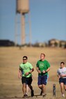 Schriever Air Force Base Airmen pace themselves during the annual St. Paddy’s Day run on the base running path Wednesday, March 8 , 2017. Airmen overcame blustery conditions to complete the 2.5-mile run. The Schriever Fitness Center sponsored the event and gave T-shirts and pedometers to participants. The top three male and top three female participants also received an Army and Air Force Exchange Service gift card. (U.S. Air Force photo/Dennis Rogers)